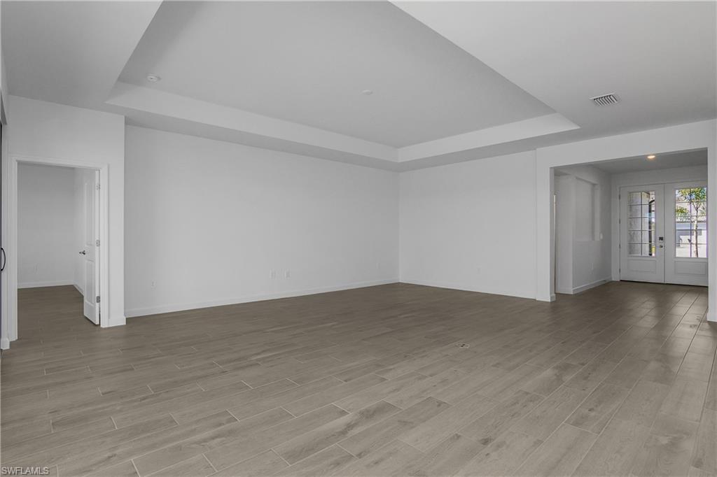 21094 Verawood Loop Estero, FL 33928 - Photo 22 of 49 an empty room with wooden floor and windows