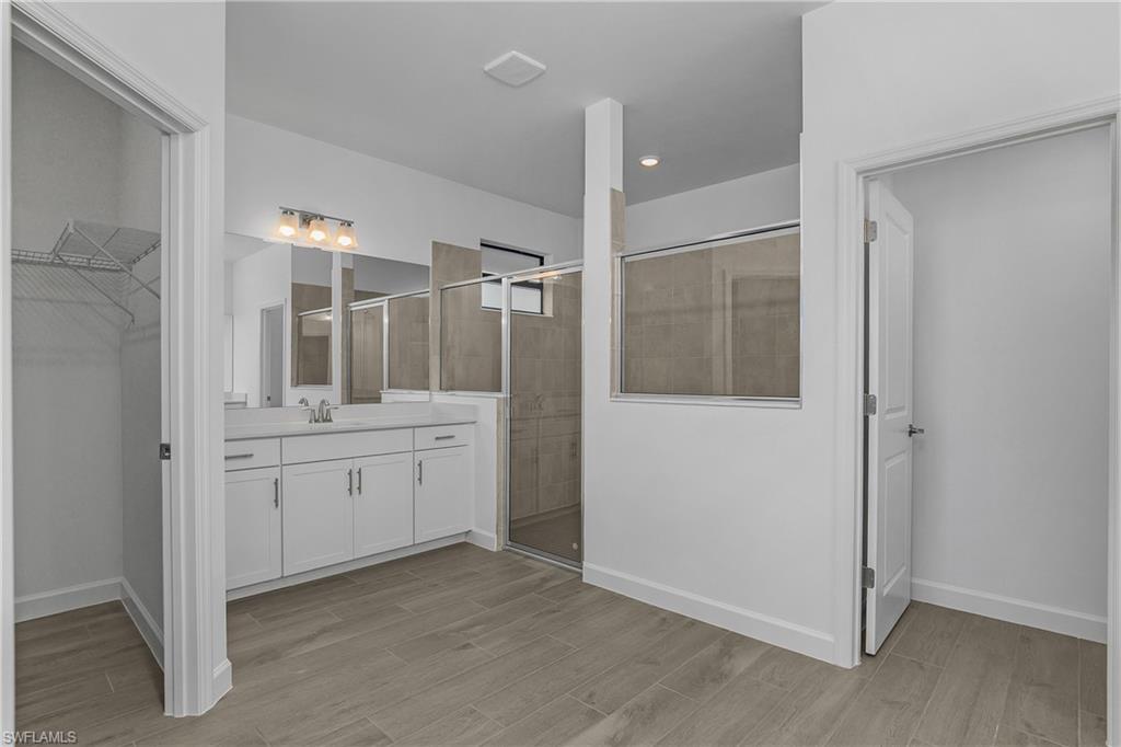 21094 Verawood Loop Estero, FL 33928 - Photo 26 of 49 a bathroom with a granite countertop sink mirror and shower