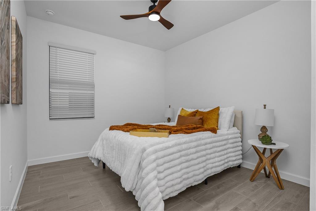 21094 Verawood Loop Estero, FL 33928 - Photo 28 of 49 a bedroom with a bed and chair