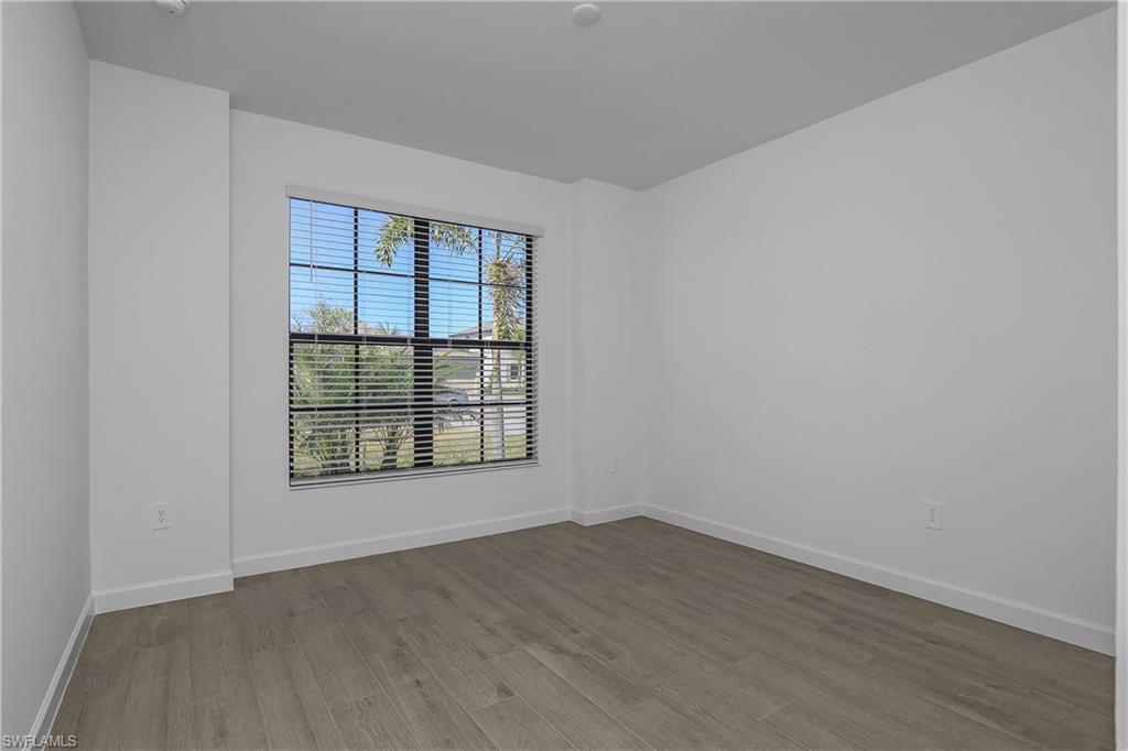 21094 Verawood Loop Estero, FL 33928 - Photo 31 of 49 an empty room with wooden floor and windows