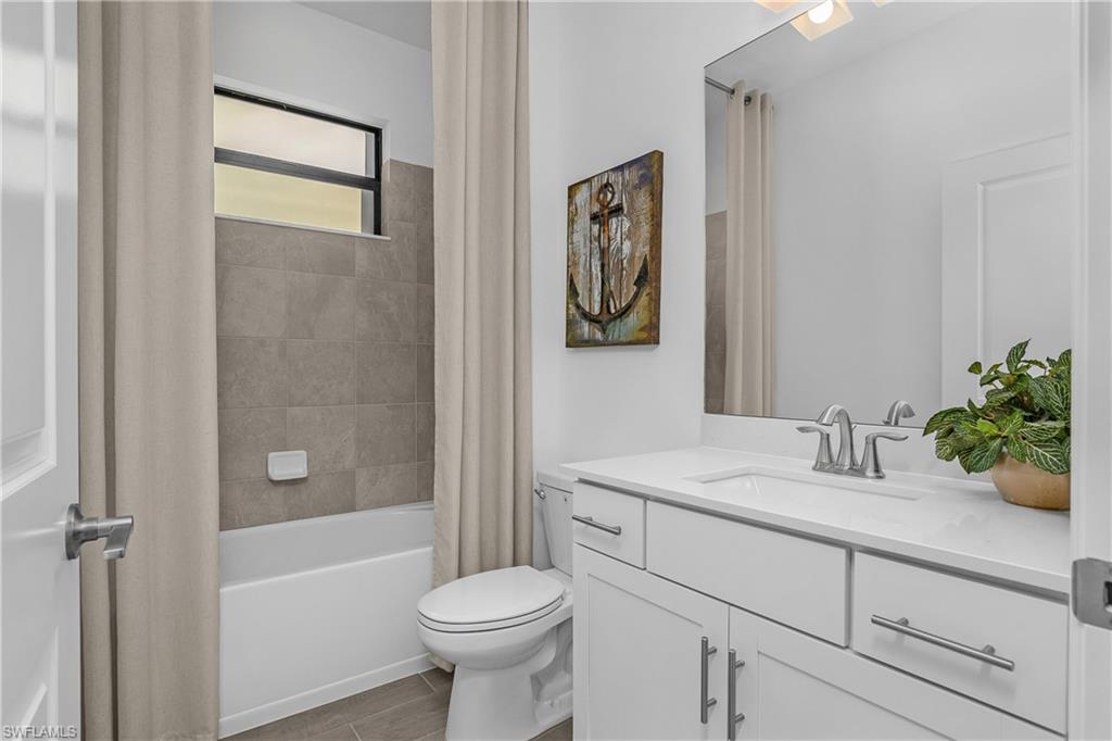21094 Verawood Loop Estero, FL 33928 - Photo 32 of 49 a bathroom with a sink a toilet and shower