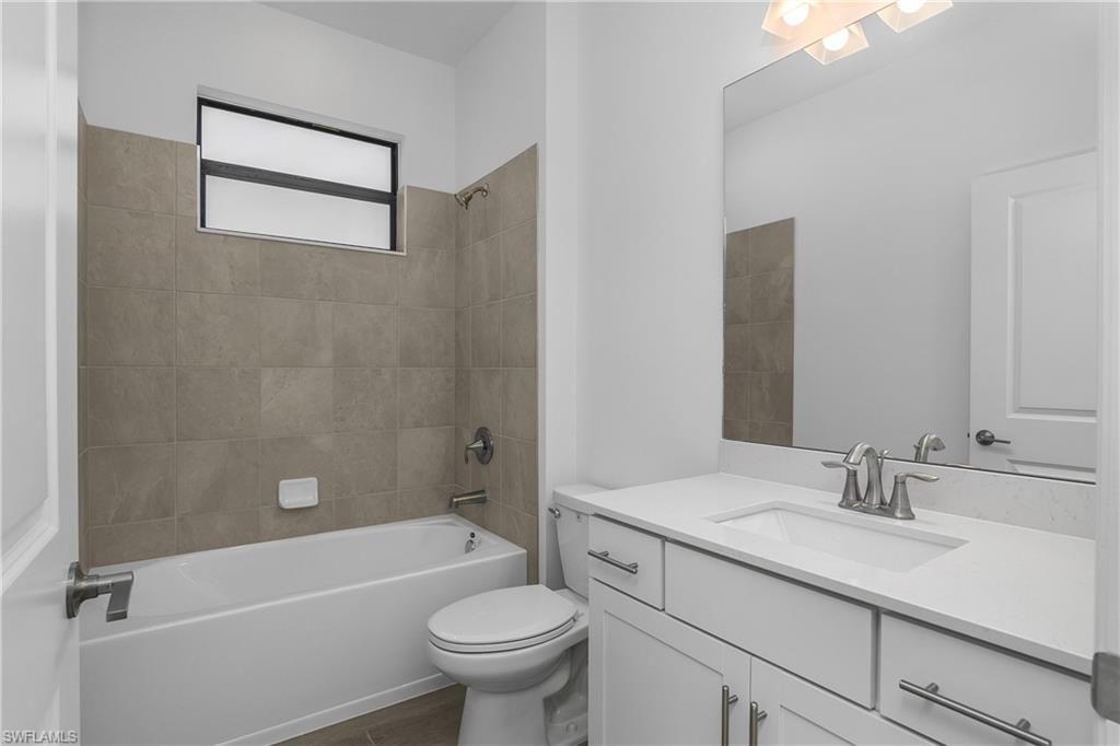 21094 Verawood Loop Estero, FL 33928 - Photo 33 of 49 a bathroom with a sink a toilet and bathtub