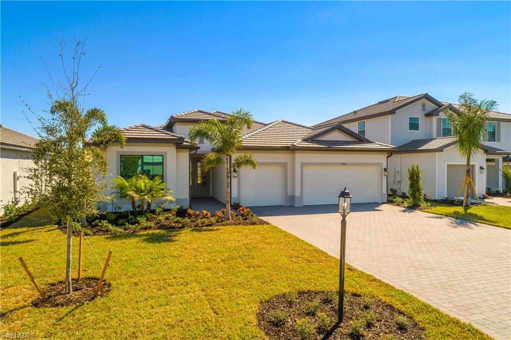 21094 Verawood Loop Estero, FL 33928 - Photo 37 of 49 a front view of a house with a yard