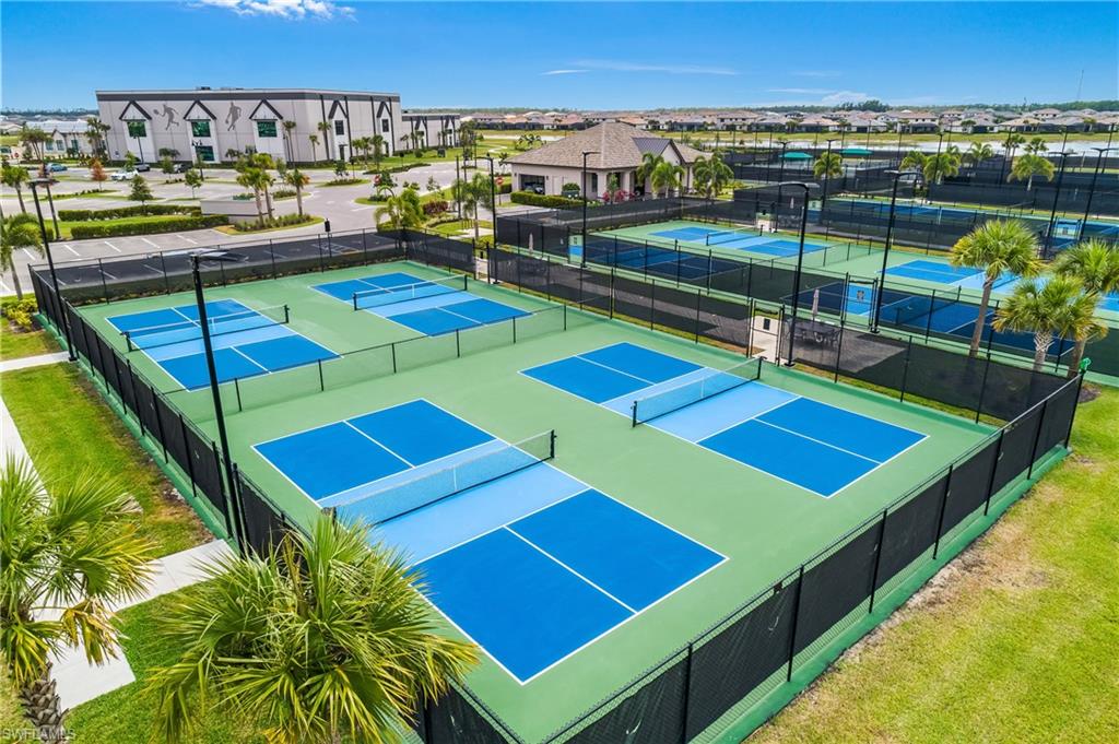 21094 Verawood Loop Estero, FL 33928 - Photo 40 of 49 a view of a tennis ground with large trees