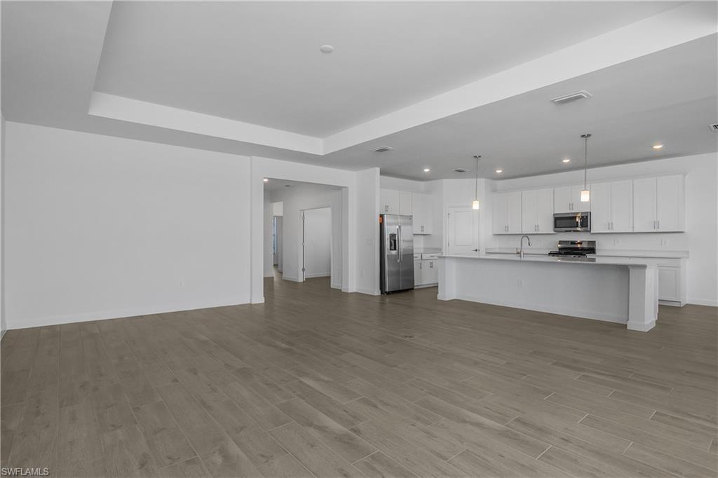 21094 Verawood Loop Estero, FL 33928 - Photo 49 of 49 a view of kitchen with kitchen island white cabinets and refrigerator