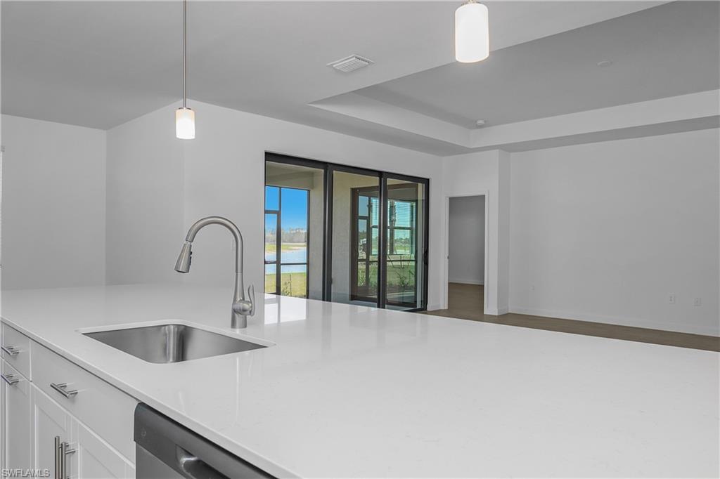 21094 Verawood Loop Estero, FL 33928 - Photo 6 of 49 a kitchen with a sink and chandelier