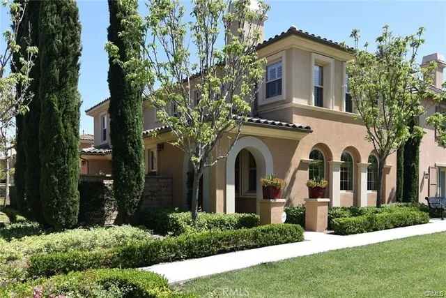 a front view of a house with yard and green space