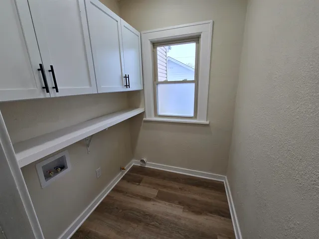 a view of room with window and cabinet