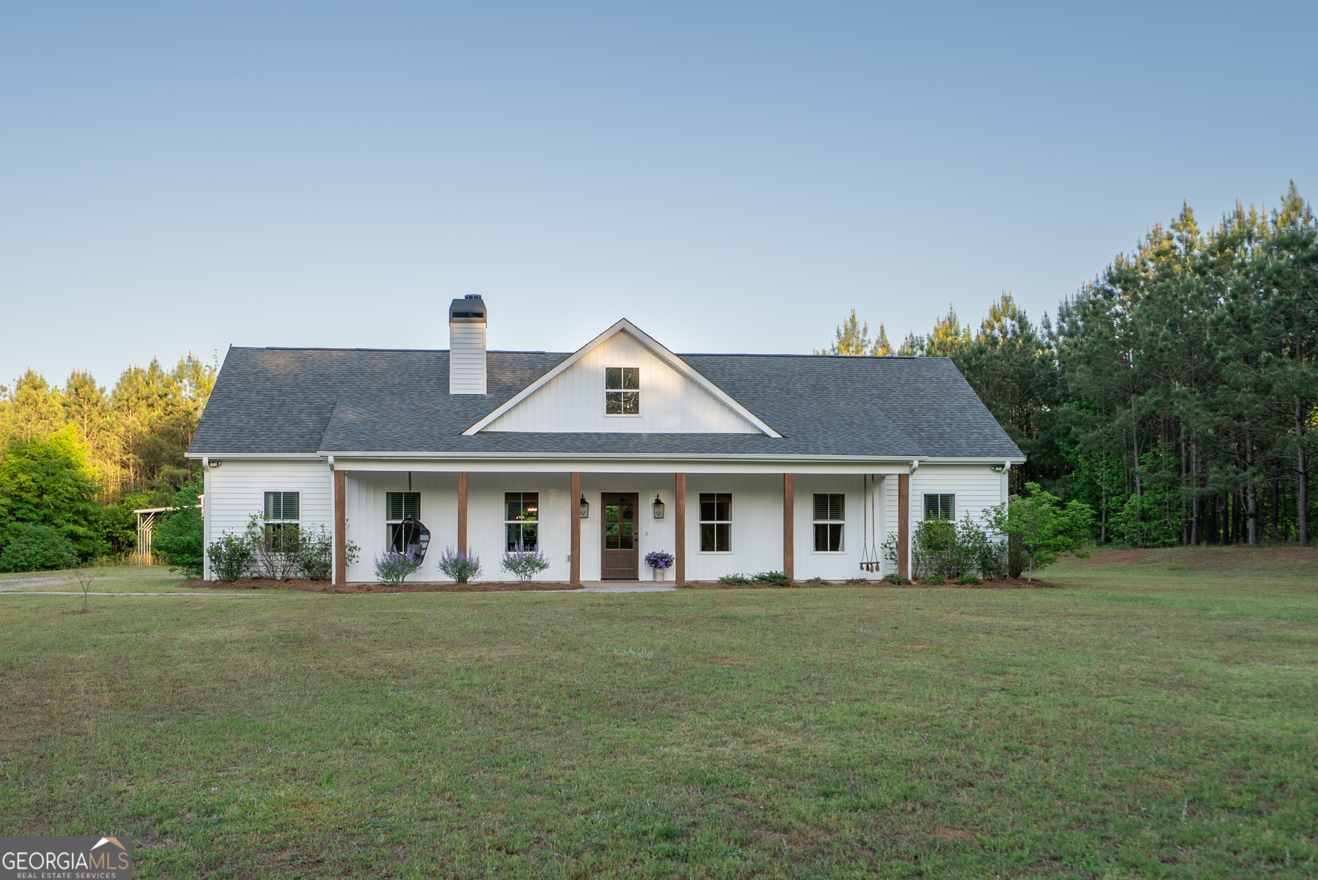 a front view of a house with a garden