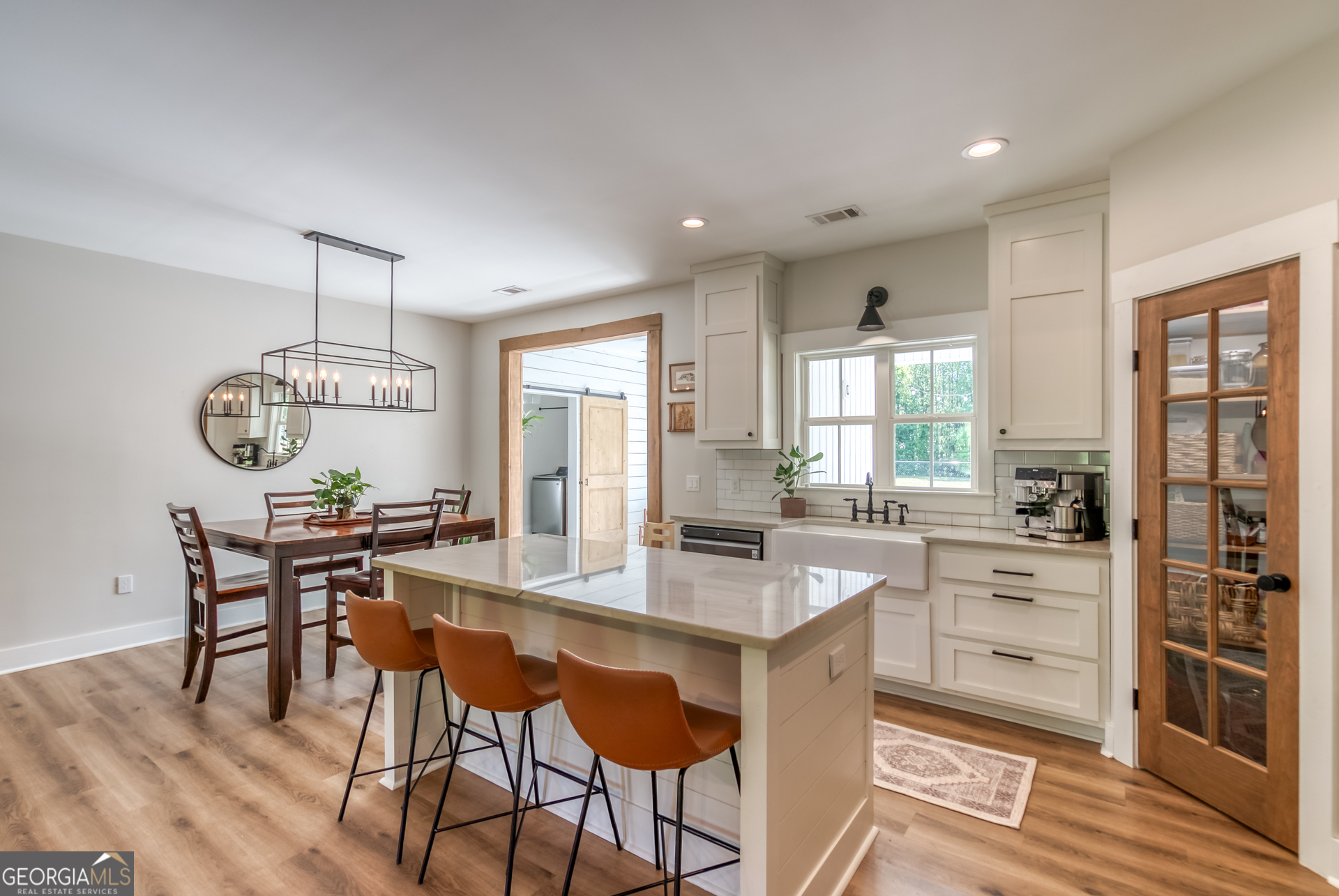 1281 Chilton Woods Road Rutledge, GA 30663 - Photo 14 of 59 a dining hall with stainless steel appliances kitchen island a table and chairs in it