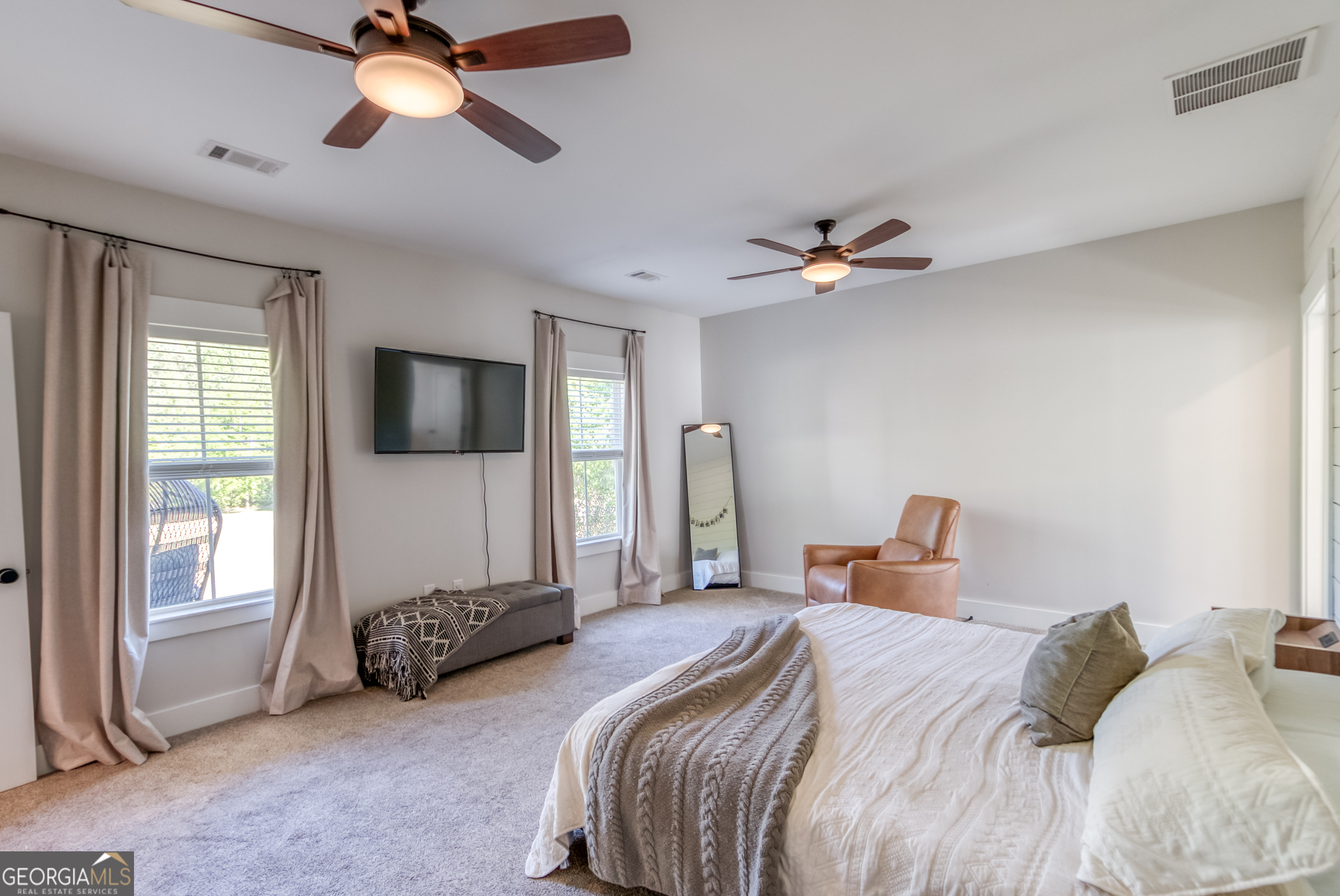 1281 Chilton Woods Road Rutledge, GA 30663 - Photo 29 of 59 a bedroom with double bed and a chandelier