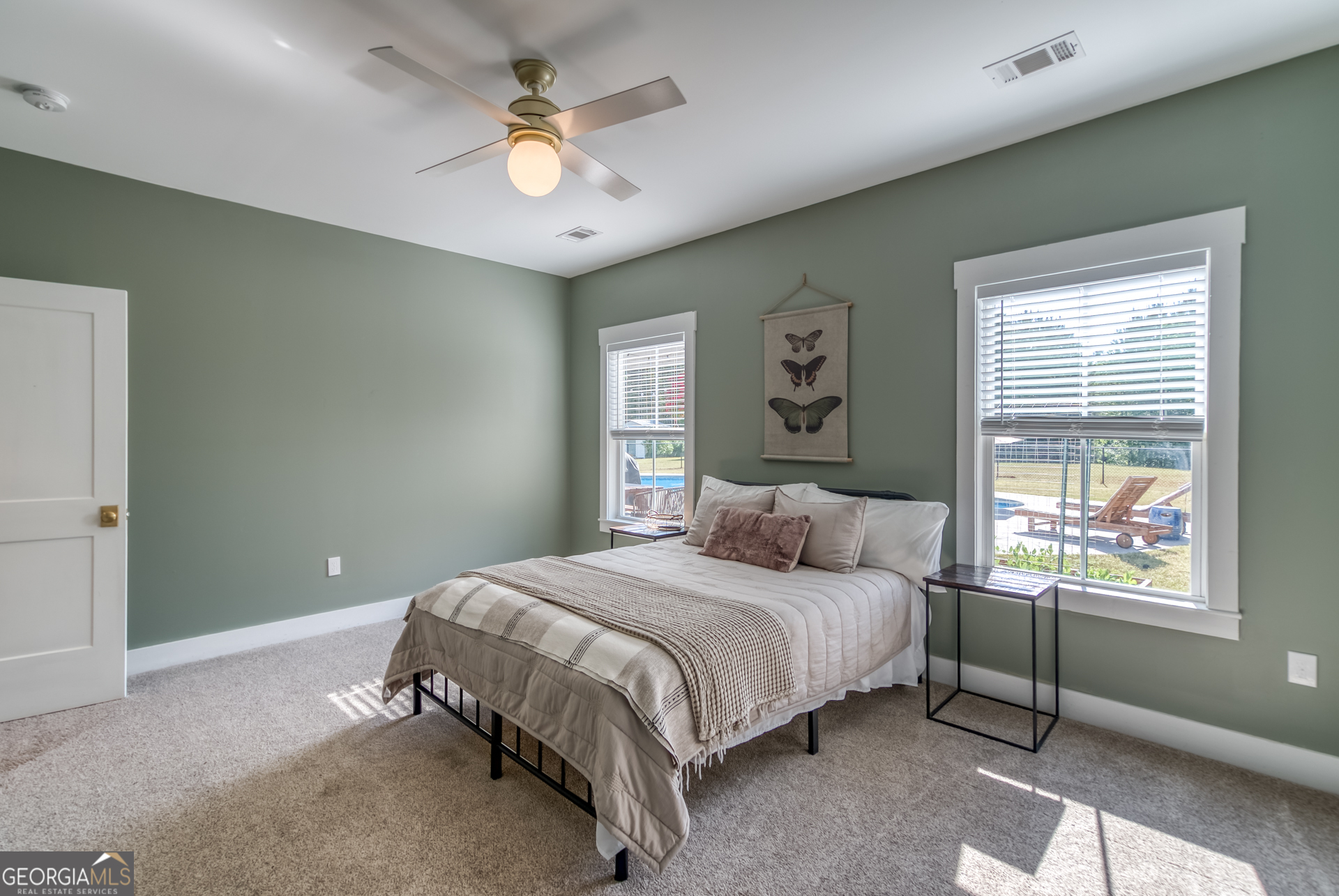 1281 Chilton Woods Road Rutledge, GA 30663 - Photo 41 of 59 a bedroom with a large bed chandelier and a window