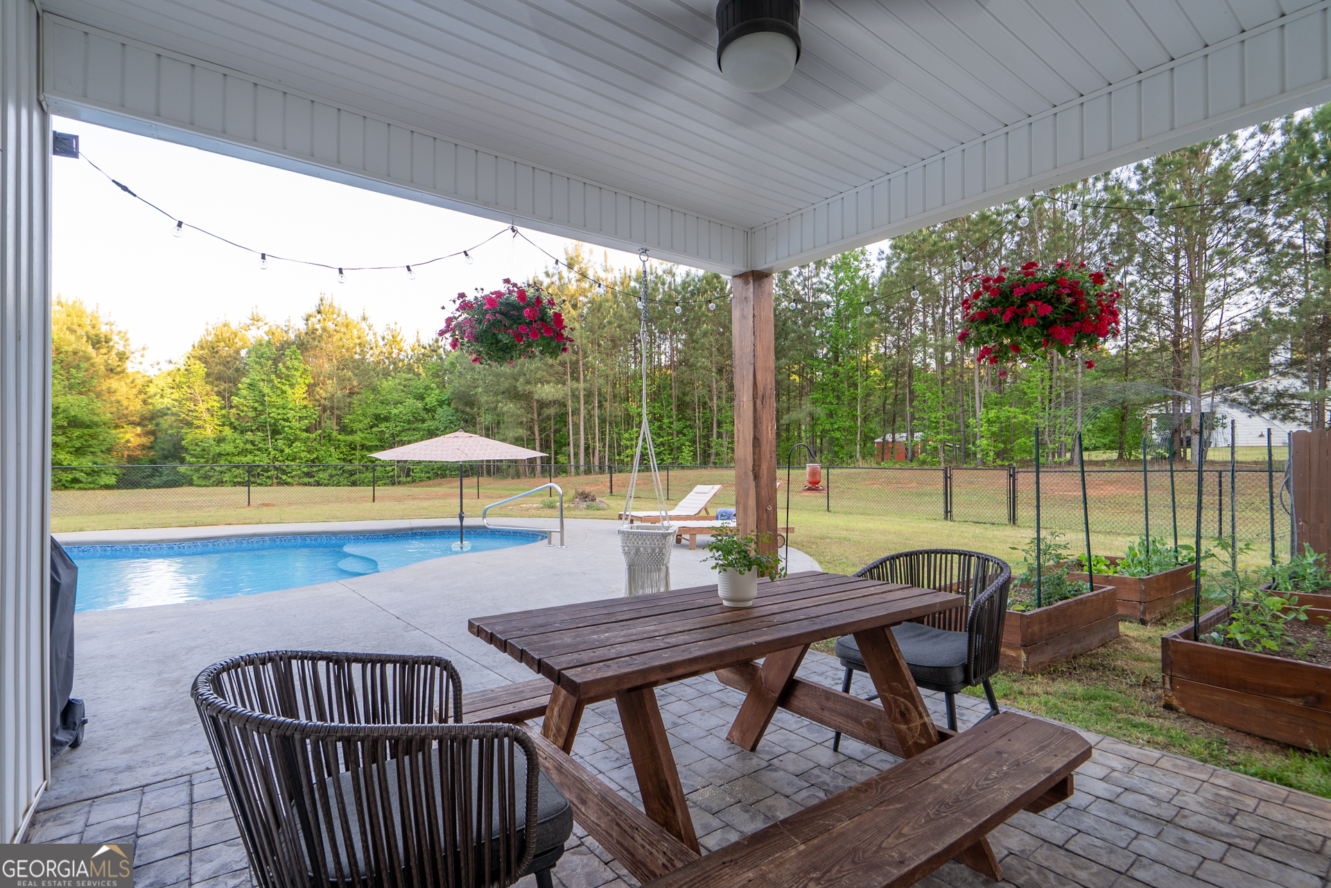 1281 Chilton Woods Road Rutledge, GA 30663 - Photo 50 of 59 a view of a patio with a table chairs and a table