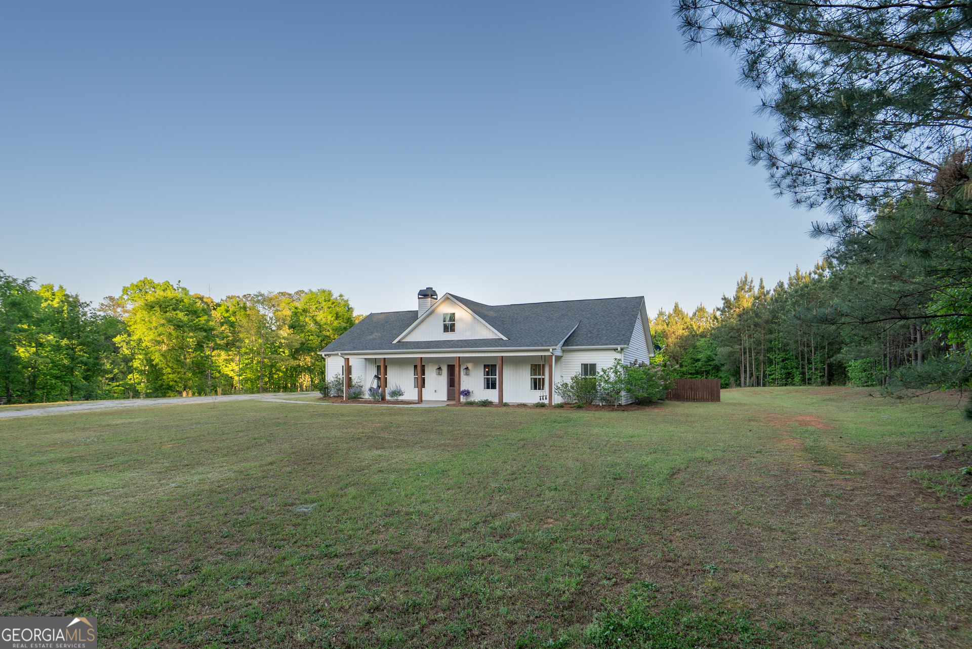 1281 Chilton Woods Road Rutledge, GA 30663 - Photo 5 of 59 a view of a large garden with plants and large trees