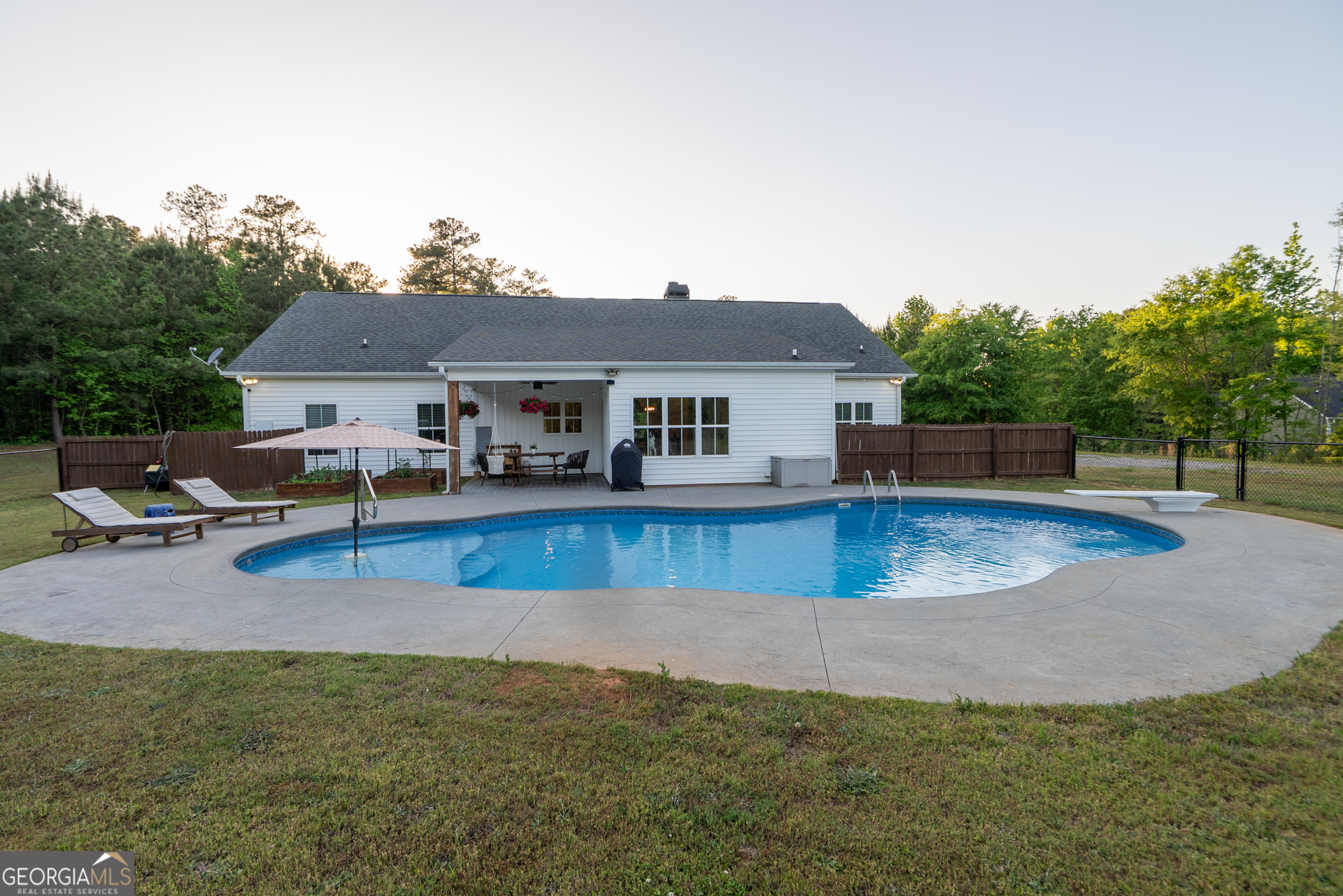 1281 Chilton Woods Road Rutledge, GA 30663 - Photo 53 of 59 a view of a house with pool and a yard
