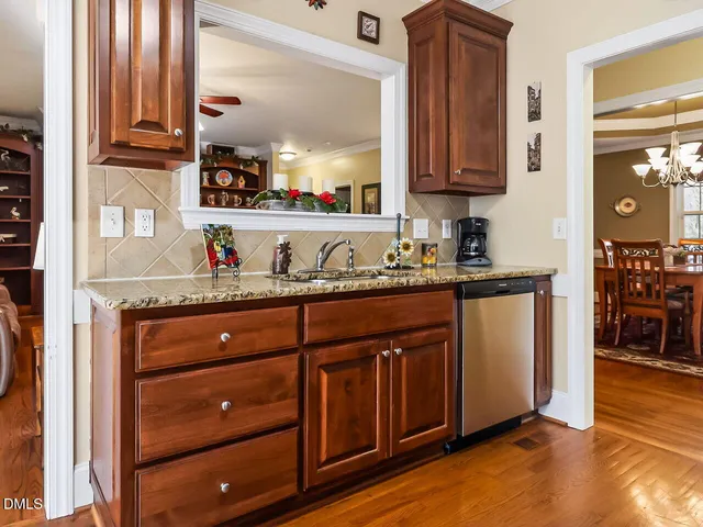 a kitchen with granite countertop wooden cabinets and a sink