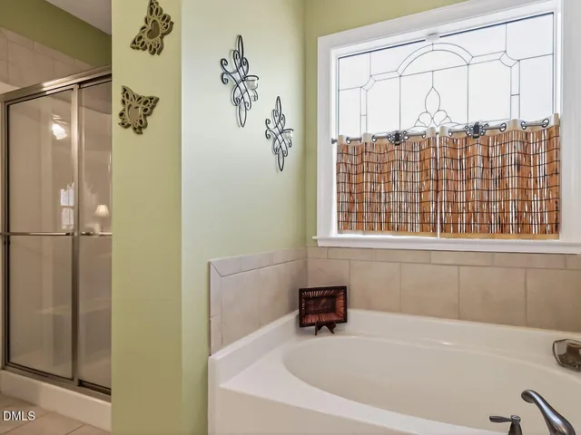 a bathroom with a bathtub and a shower