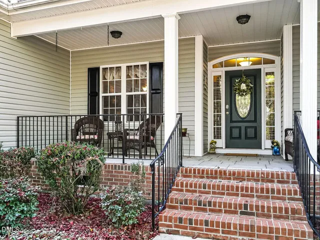 a front view of a house with outdoor seating