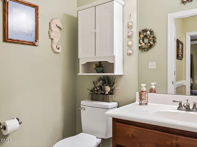 a bathroom with a sink mirror and toilet