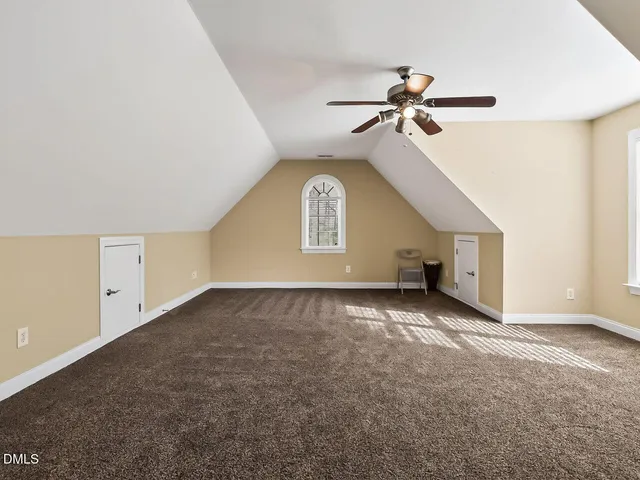 a view of a livingroom with a ceiling fan and window