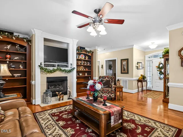 a living room with furniture a flat screen tv and a fireplace