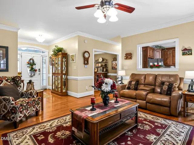a living room with furniture a rug and a chandelier