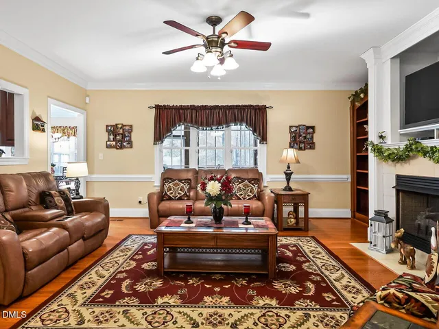 a living room with furniture fireplace and a flat screen tv