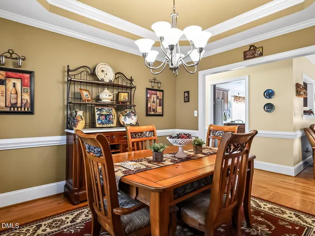 a view of a dining room with furniture and chandelier