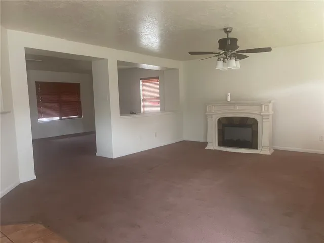 a view of empty room with a fireplace