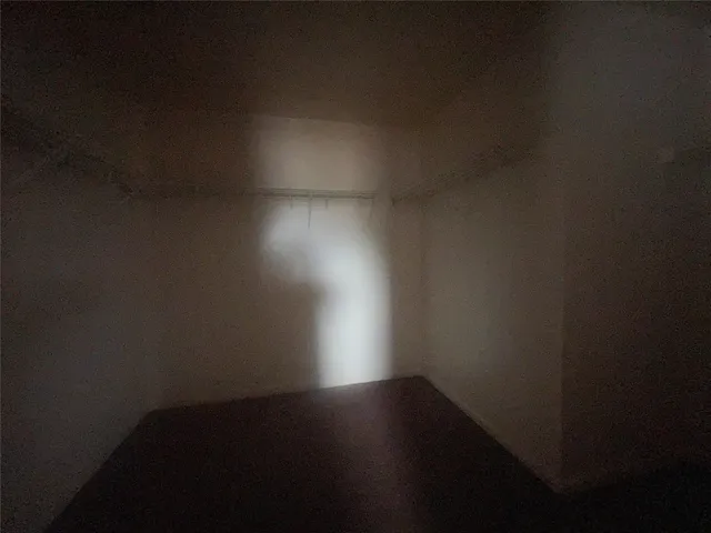 a view of room with wooden floor and windows