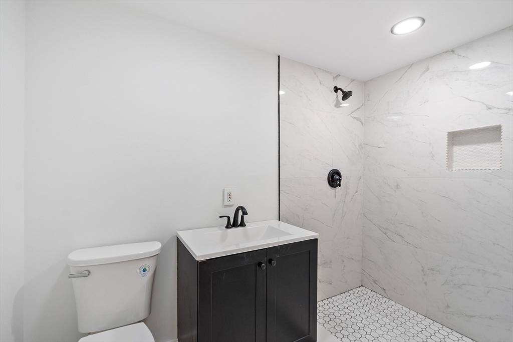 43 Public Road Lancaster, MA 01523 - Photo 12 of 31 a bathroom with a sink a toilet and shower