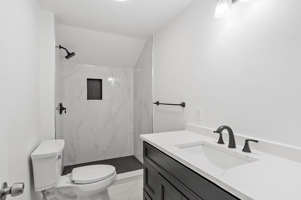 43 Public Road Lancaster, MA 01523 - Photo 21 of 31 a bathroom with a toilet a sink and mirror