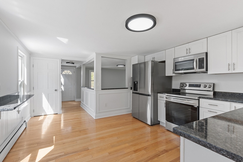 43 Public Road Lancaster, MA 01523 - Photo 6 of 31 a large kitchen with cabinets stainless steel appliances and a counter space
