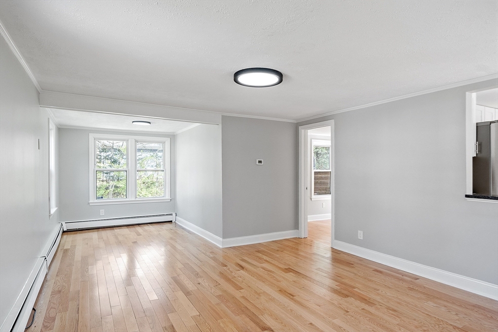 43 Public Road Lancaster, MA 01523 - Photo 7 of 31 an empty room with wooden floor and windows
