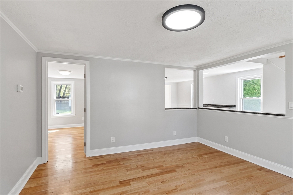 43 Public Road Lancaster, MA 01523 - Photo 9 of 31 an empty room with wooden floor and windows