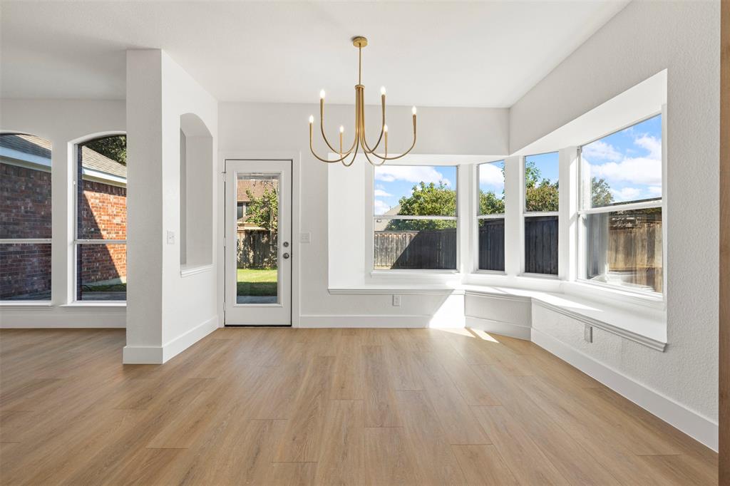 421 Ridge Meade Drive Lewisville, TX 75067 - Photo 15 of 36 a view of an empty room with wooden floor and a window