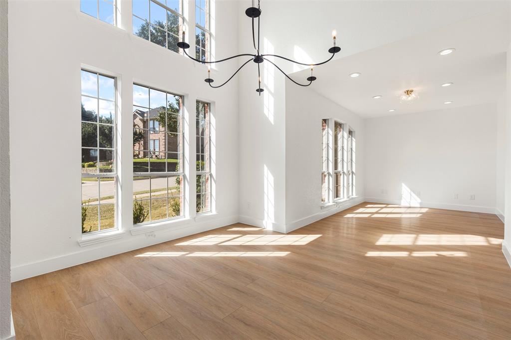 421 Ridge Meade Drive Lewisville, TX 75067 - Photo 18 of 36 a view of empty room with wooden floor and fan