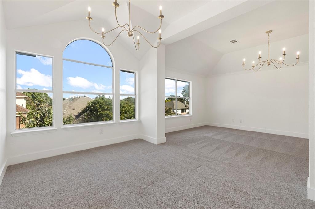 421 Ridge Meade Drive Lewisville, TX 75067 - Photo 20 of 36 an empty room with windows and chandelier