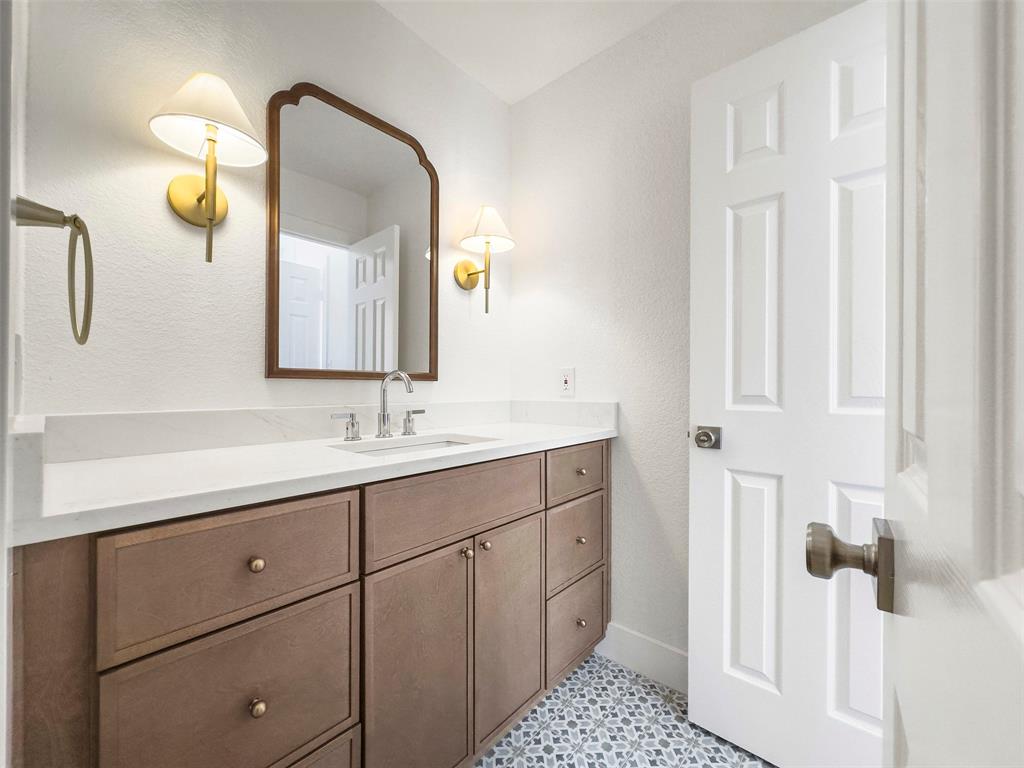 421 Ridge Meade Drive Lewisville, TX 75067 - Photo 28 of 36 a bathroom with a sink and a mirror