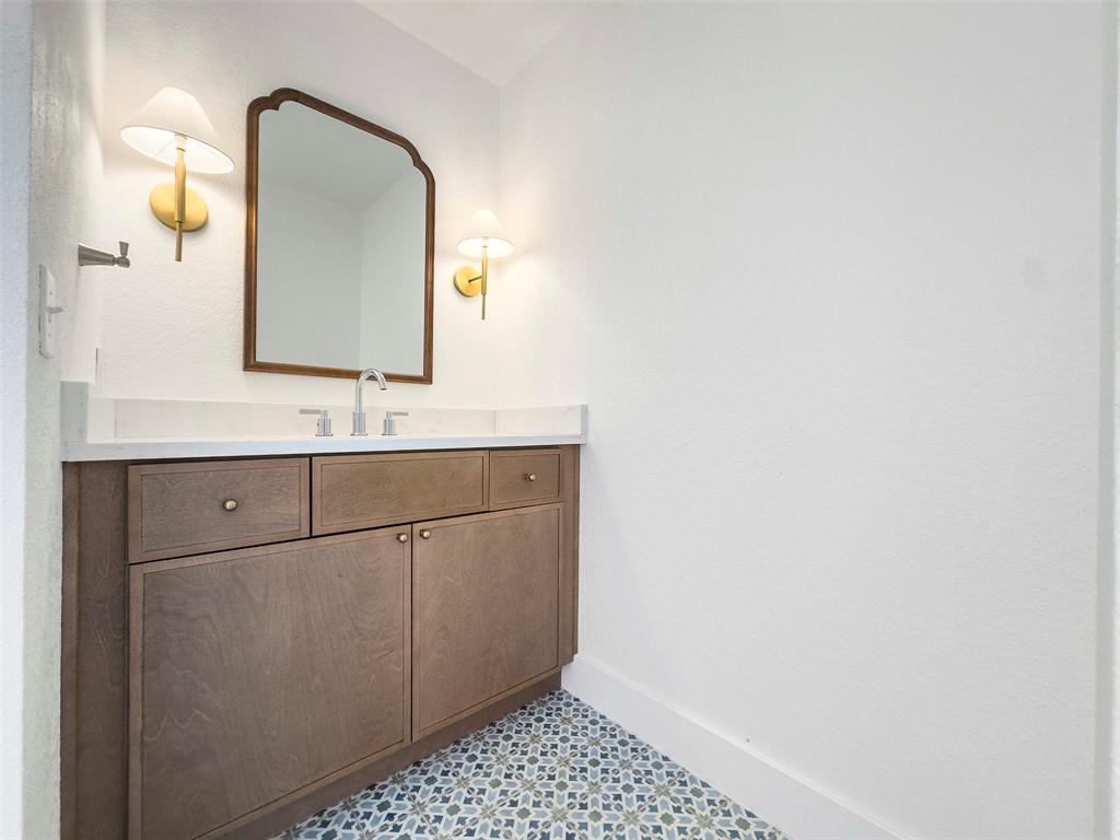 421 Ridge Meade Drive Lewisville, TX 75067 - Photo 29 of 36 a bathroom with a sink and a mirror