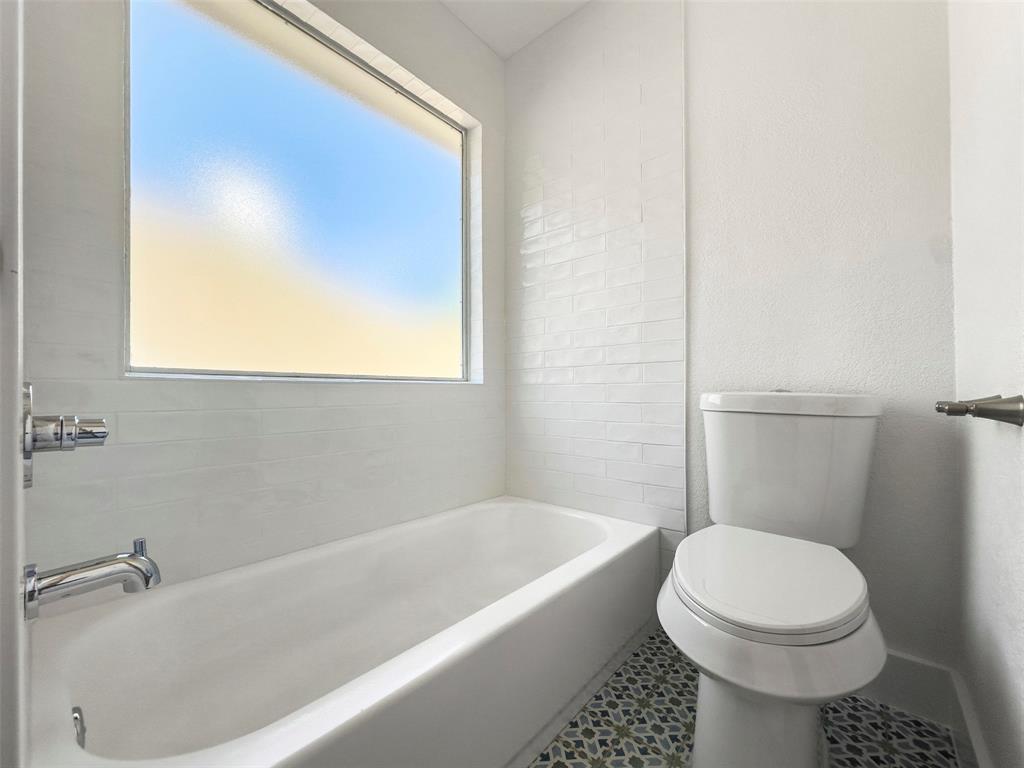 421 Ridge Meade Drive Lewisville, TX 75067 - Photo 30 of 36 a bathroom with a sink and a toilet