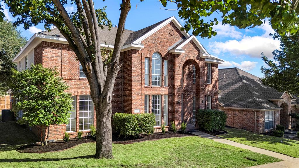 421 Ridge Meade Drive Lewisville, TX 75067 - Photo 32 of 36 front view of a house with a yard