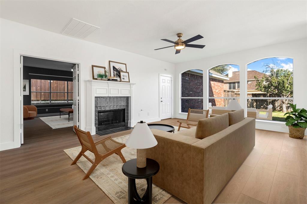 421 Ridge Meade Drive Lewisville, TX 75067 - Photo 5 of 36 a living room with furniture and a fireplace