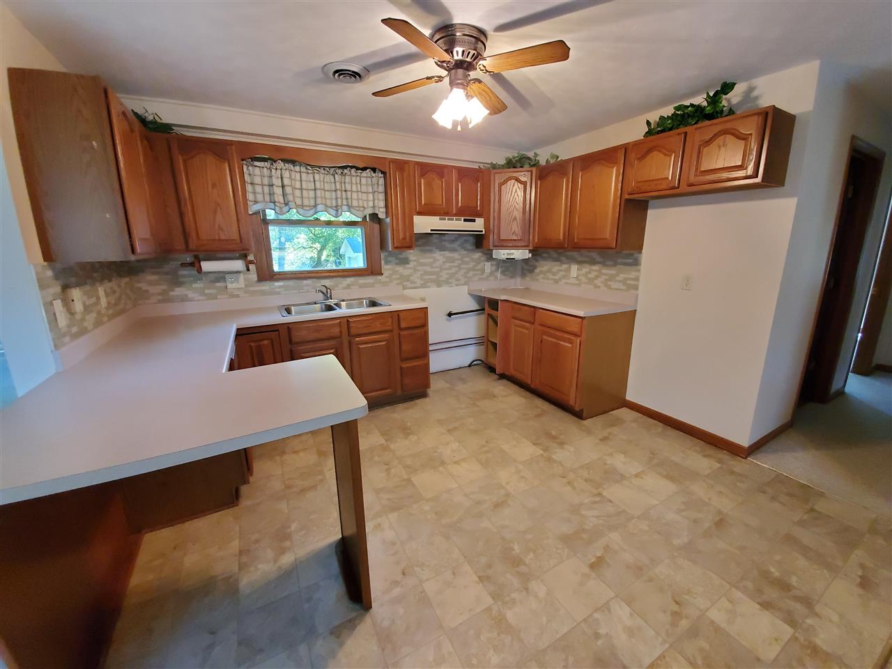 1176 Daysville Road Oregon, IL 61061 - Photo 6 of 34 a kitchen with a stove a refrigerator and wooden cabinets