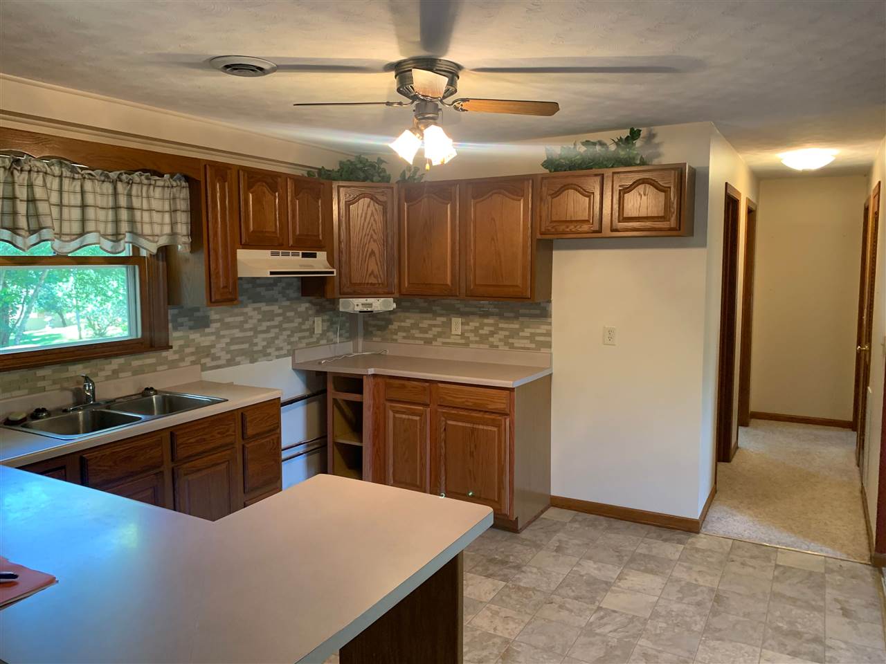 1176 Daysville Road Oregon, IL 61061 - Photo 7 of 34 a kitchen with stainless steel appliances granite countertop a sink a stove and a refrigerator