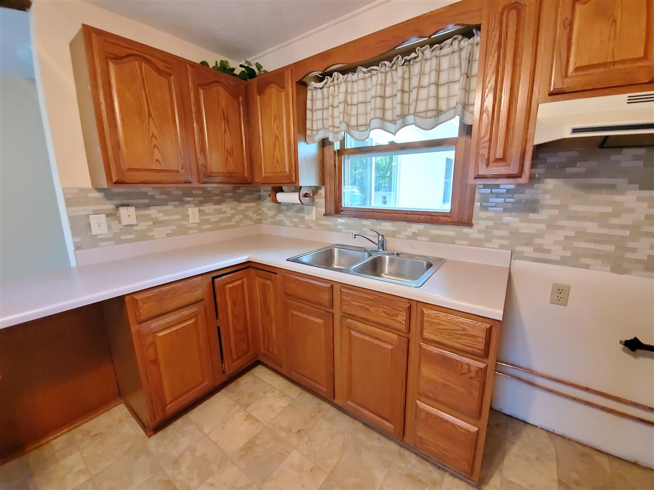 1176 Daysville Road Oregon, IL 61061 - Photo 8 of 34 a kitchen with granite countertop wooden cabinets a sink and a window