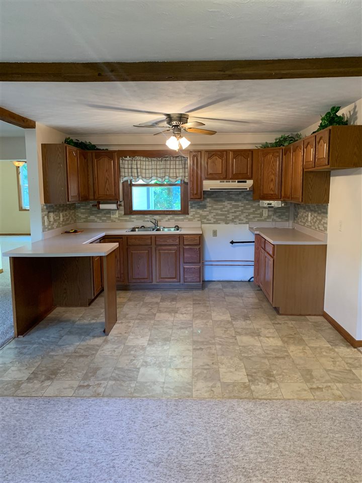 1176 Daysville Road Oregon, IL 61061 - Photo 10 of 34 a kitchen with stainless steel appliances granite countertop a sink and cabinets
