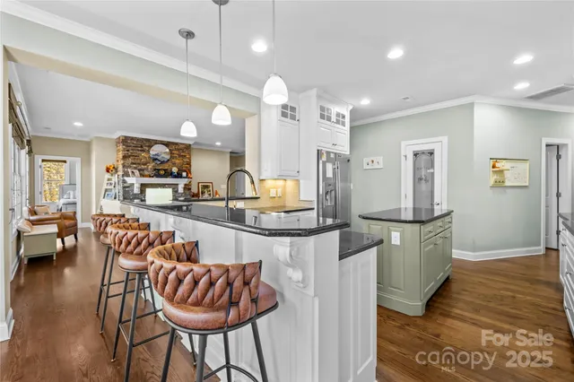 a kitchen with granite countertop a counter space a sink appliances and cabinets