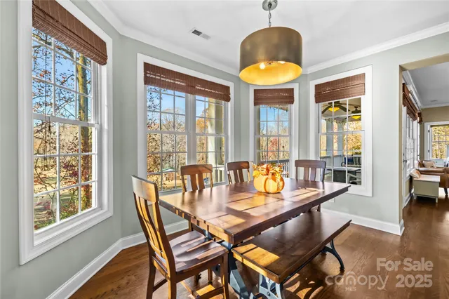 a dining room with furniture and wooden floor