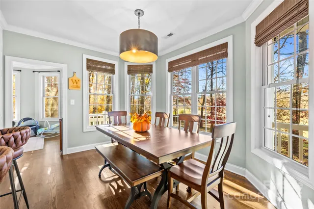 a view of a dining room with furniture wooden floor and chandelier